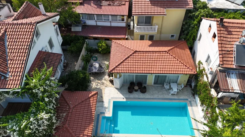 Göcek çarşı villasında taş avlu turkuaz havuz ve dış oturma